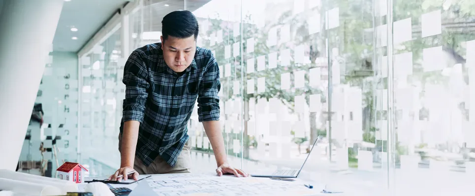 construction-estimator-looking-over-blueprints