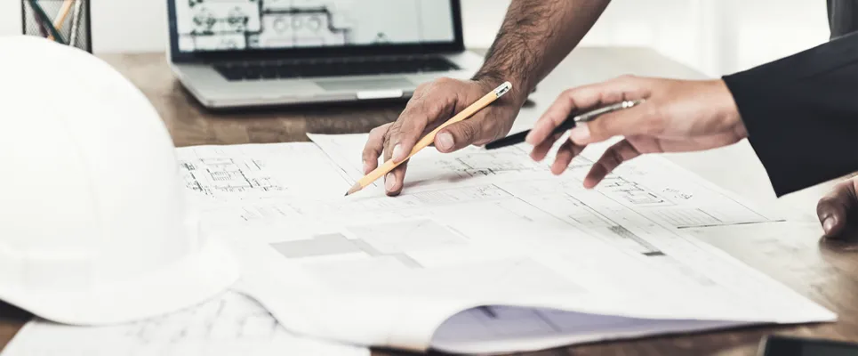 a contractor looking over a set of blueprints